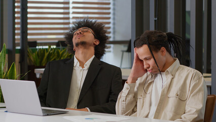 Two African American men business guys colleagues desperate stressed worried businessmen coworkers...