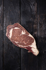 Wagyu steak on a rustic wooden background, top view, copyright