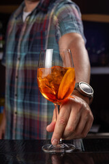 Bartender is making cocktail at bar counter, closeup.