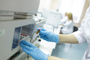 Laboratory Technician Conducting Medical Analysis with Sample Vials in Modern Clinical Research...