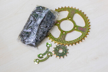 New motorcycle chain and sprocket set for bike maintenance. Essential parts for drivetrain repair...