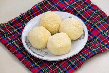 Popular Bengali Kachagolla sweets on a ceramic plate. Enjoy this delicacy with its soft, spongy...