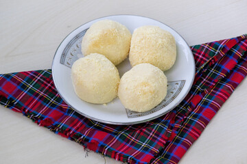 Popular Bengali Kachagolla sweets on a ceramic plate. This tasty treat is known for its soft, spongy texture and subtle sweetness.