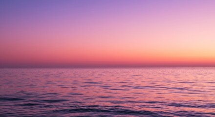Obraz premium Calming ocean scenery at sunset with pink and purple sky background