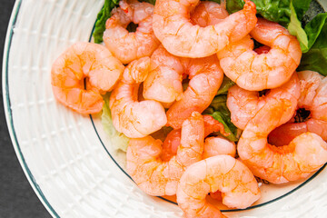 Shrimp salad prawns seafood fresh pescetarian diet gourmet food background on the table rustic food...