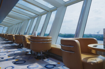 Luxurious modern observation or panorama lounge with floor to ceiling windows onboard expedition...