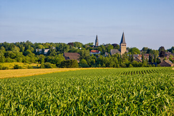 the two churches called Wiesnasen of Ratingen Homberg at summer	evenig sun with blue sky and corn fields
