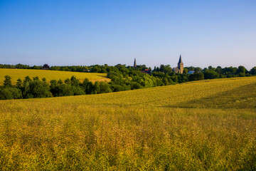 the two churches called Wiesnasen of Ratingen Homberg at summer	evenig sun with blue sky and rye field