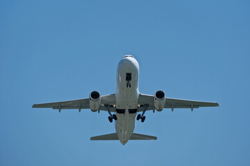 Airplane in the blue sky. Airplane taking off against blue sky