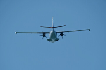 Airplane in the blue sky. An airplane moving away after takeoff