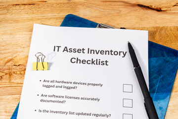 IT Asset Inventory Checklist with Pen on Desk – Technology Management and Audit Concept