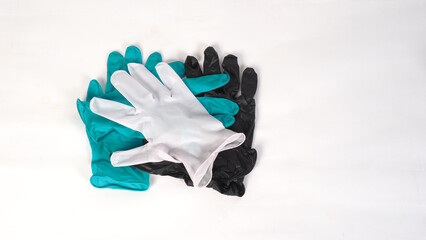 Latex gloves in white black and green color on white background.