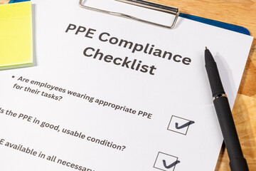 PPE Compliance Checklist Document with Pen on Desk – Workplace Safety and Equipment Regulation...