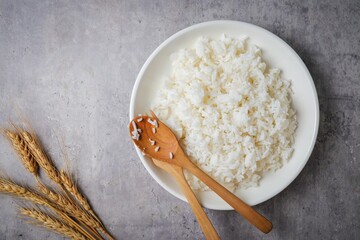 Cooked white rice or steamed rice in a white plate, with spoon and fork ,thai jasmine rice, thai...