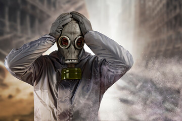 Post apocalyptic survivor man in a gas mask and protective suit