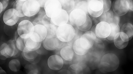 Obraz premium Abstract grayscale bokeh background with bright and dark circles.