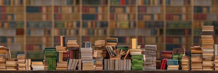 Stacks of many books on a shelf or table. Concept of library, reading, old classic literature