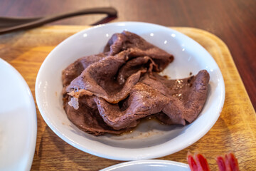 Grilled wagyu beef, well done cooking, in white bowl for a meal