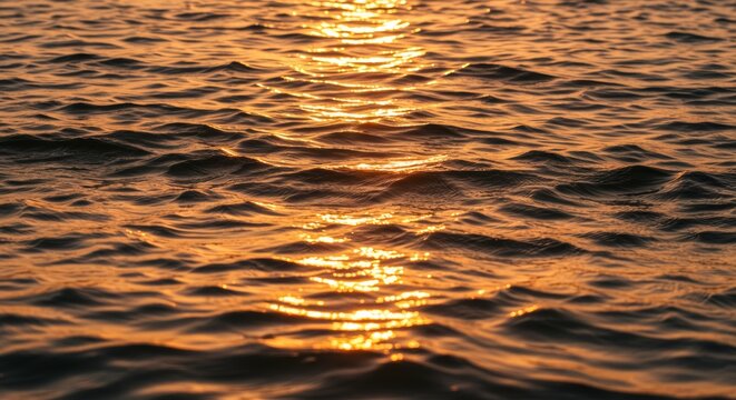 Golden hour seascape shimmering water reflecting sunlight at sunset calmness