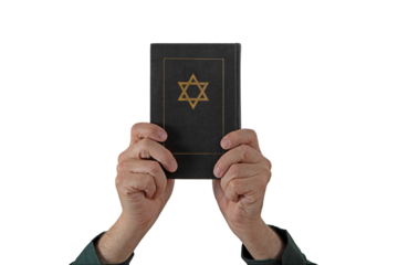 Hands and Hebrew Book Talmud with Star of David on a dark cover on isolated background. Rabbinic Judaism, Studying Jewish religious law. Torah, Hebrew Bible. Holy Scripture containing the word of God