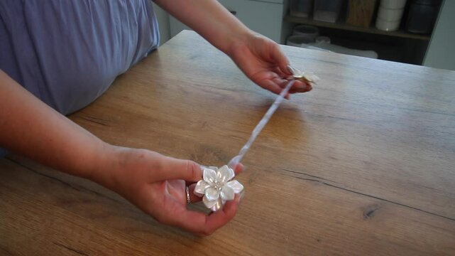 Woman demonstrating magnetic curtain holder while reviewing the purchase.