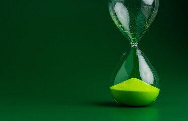 Hourglass stops time of work and life. Process and rules of limited time. Hourglass photo in studio.