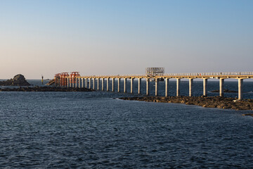 Obraz premium Sunset over Roscoff estacade landing stage for Île de Batz shuttle, Brittany, France