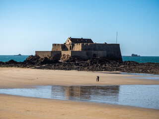 17th-century Vauban fort in Saint-Malo with couple walking nearby