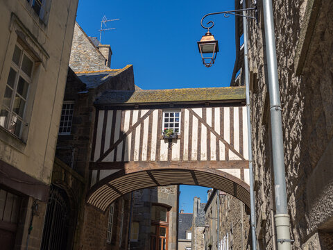 Half-timbered bridge house over a narrow medieval street in Saint-Malo, Brittany, France