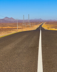 A road reaches the horizon as it crosses the desert in Saudi Arabia.