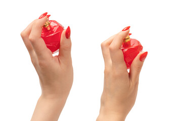 Red bottle of perfume in woman hand with red nails isolated on a white background.