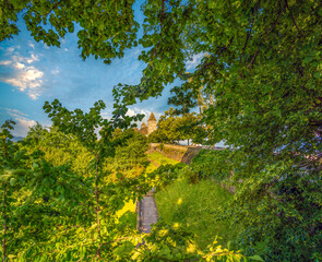 Lush summer forests and historical buildings in the Deer Park (Hirschpark) on top of the Lindenhof hill, Rapperswil, St. Gallen, Switzerland.