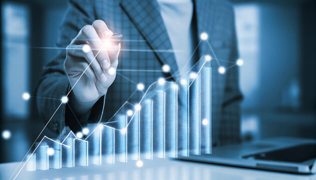 Man in Suit Drawing Rising Bar Graph with Glowing Connections and Laptop