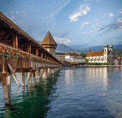 The hitoric Chapel Brdige (Kappelbrücke) and its water tower (Wasserturm) in Luzern (Lucerne), Switzerland. Mt. Pilatus and the Jesuit church in the background