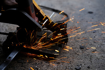 cutting a steel plate with an electric cutting wheel at a factory
