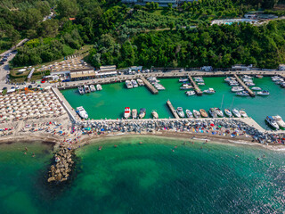 Italy, June 22, 2025: aerial view from the drone of the Vallugola Bay with its tourist port...