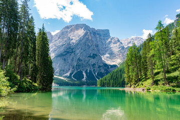 A breathtaking view of a serene alpine lake with vibrant turquoise-green water.