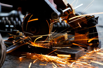 cutting a steel plate with an electric cutting wheel at a factory