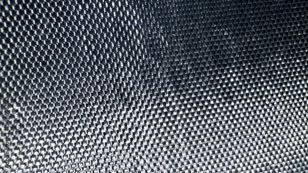 Poster close-up of black carbon fiber texture with metallic sheen and tight weave pattern for modern tech d