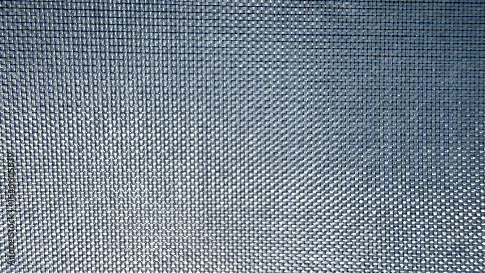 Poster close-up texture of metallic mesh grid with radial light reflection pattern in dark blue tones, ideal for tech background, product packaging, or digital design

