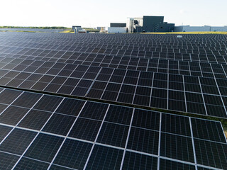 Modern green factory powered by renewable solar energy. Sustainable development in industry