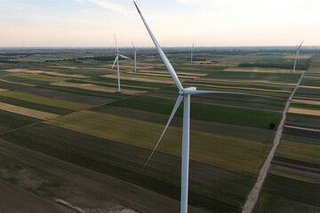 Aerial view of wind turbine on an agricultural filed at sunset. Close up of blades