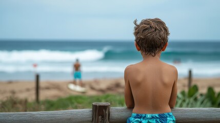 A young boy stands at the beach, mesmerized by the waves, embodying innocence and the joy of childhood as he watches surfers ride the ocean's crest.