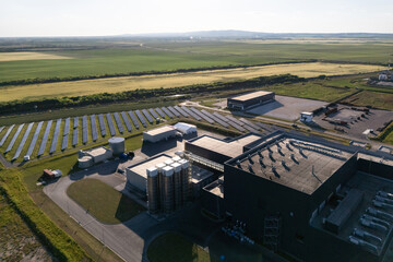 Modern green factory powered by renewable solar energy. Sustainable development in industry