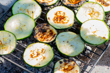 a lot of delicious grilled zucchini on the grill. High quality photo
