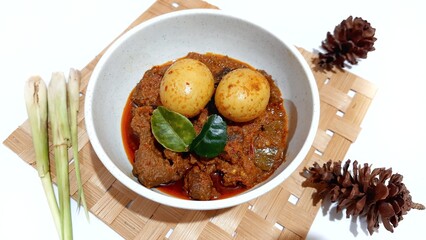 Beef Toppa Lada with eggs served in a white bowl. Popular Indonesian food from Makassar, South Sulawesi