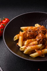 Penne pasta with meatballs in tomato sauce with salt and spices. Italian food penne pasta
