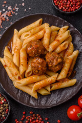 Penne pasta with meatballs in tomato sauce with salt and spices. Italian food penne pasta
