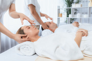 Caucasian couple enjoying relaxing anti-stress head massage and pampering facial beauty skin...