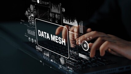 Hands Typing on Laptop with Data Mesh Conceptual Visualization and Digital Graphs on Screen....